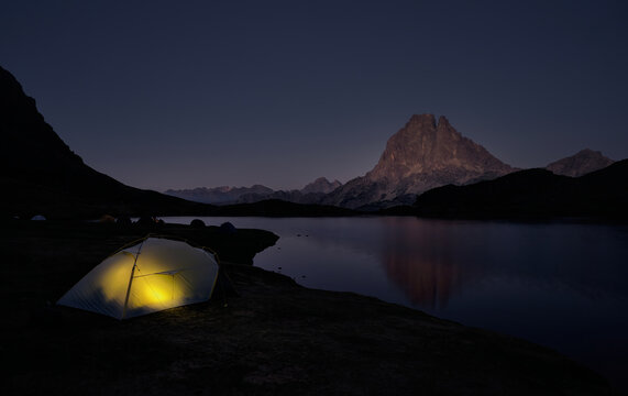Tent camping with light on Lake Gentau, Ayous in the Natural Park of the Pyrenees, France