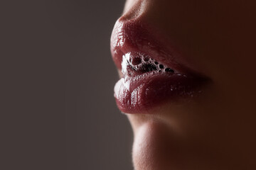 Passionate lips. Female open mouth with saliva. - obrazy, fototapety, plakaty