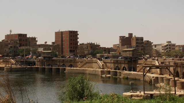 The aqueduct of Assuit city showing Nile river and buildings in the background in Egypt
