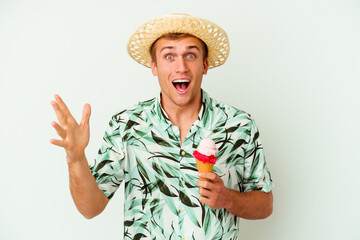 Fototapeta premium Young caucasian man wearing a summer clothes and holding a ice cream isolated on white background
