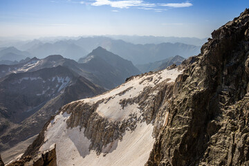Impressive image of a mountain range from the top of a mountain with snow and steep walls