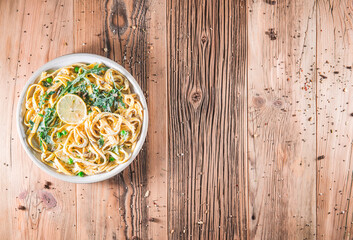 Pasta with a sour cream lemon and herbs on wooden table