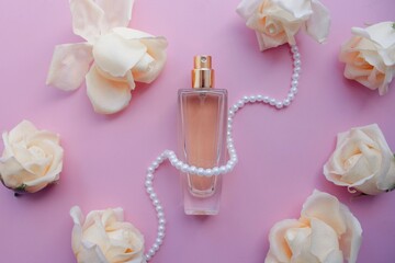 perfume with roses on a pink background