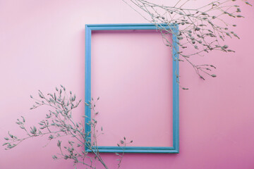 Dry grass agains with blank picture frame for quote mock-up on a pink  background 