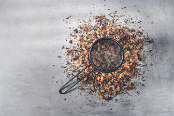 Fruit tea of dried flowers petals and dry berries with strainer or infuser - filter