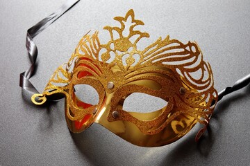 Golden carnival mask on black background. Mardi gras mask.
