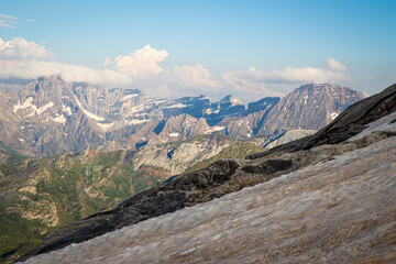 Panoramic view of snow-capped mountains from a glacier in summertime