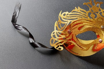 Golden carnival mask on black background. Mardi gras mask.
