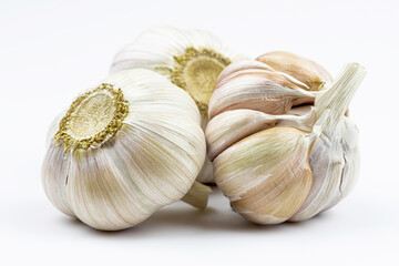 Three heads of garlic are isolated on a white background.