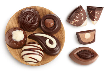Chocolate candy in wooden bowl isolated on white background with clipping path and full depth of field. Top view. Flat lay