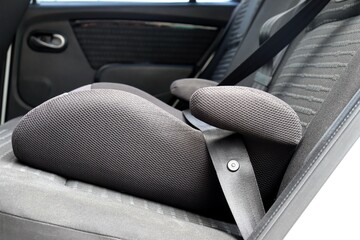 Safety booster seat for children. Car interior.

