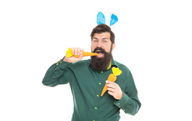 Delicious Easter treats. eastertide. happy bearded man wear bunny ears. happy easter carrot.