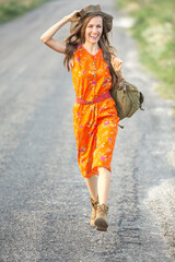 portrait of a woman with backpack on the road

