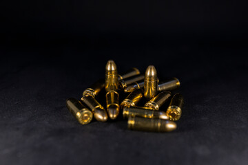 9 mm bullets on a black background. Photo with shallow depth of field.