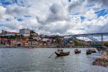 Obraz premium Oporto, Portugal, Europe. Postcard from the picturesque city of Porto, amazing travel destination in Portugal. View to the historic center, Douro River with its beautiful bridge and old monuments.