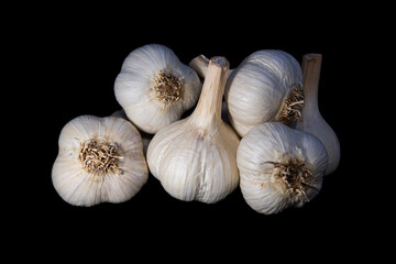 Pile of garlic on a black background. Photo with shallow depth of field.