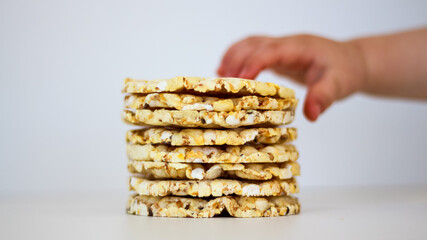 Hands of the child with puffed rice cakes