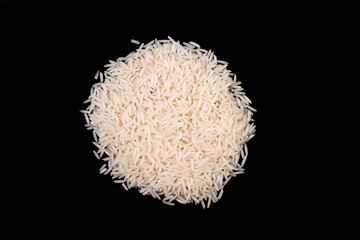 Heap of white rice isolated on black background. rice close-up.