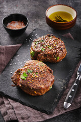 Grilled beef fillet steaks with herbs and spices on stone slate. Two Fillet mignon. Fillet of beef.