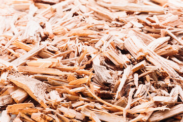 Small pile of wood chips close up background. Waste from the woodworking industry, fuel and raw...