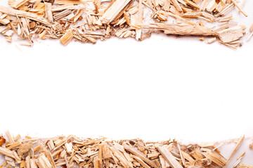 Wood chips arranged in stripes on top and bottom of image on white background. Top view with copy space. Flat lay.