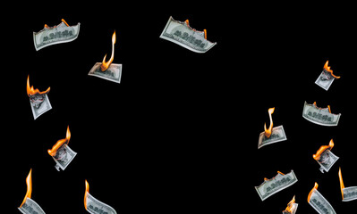Several 100 dollar bills, falling down, burn on a black background. The concept of bankruptcy,...
