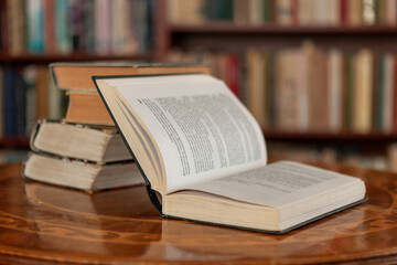 Open book and Pile of old books against the background of the home library