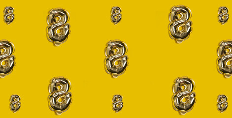 Pattern Golden helium balloon number 8 on a Yellow Background. International Women's Day and March 8