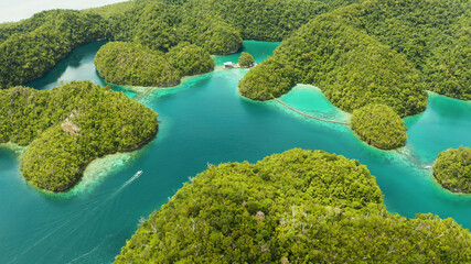 Cove and blue lagoon among small islands covered with rainforest. Sugba lagoon, Siargao, Philippines. Summer and travel vacation concept.