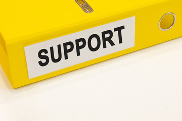 The word support on a white background with a yellow folder. Business concept