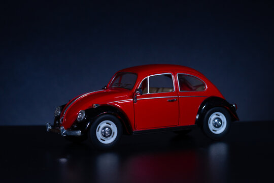 mariupol, donetska obl, ukraina, 23.12.2020 - toy car of red color on a black background. small copy of a retro car