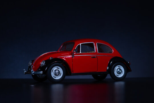 mariupol, donetska obl, ukraina, 23.12.2020 - toy car of red color on a black background. small copy of a retro car