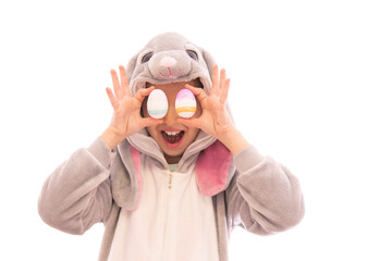 Girl in bunny costume covered her eyes with eggs and laugh. isolated on white. easter holiday concept. high quality