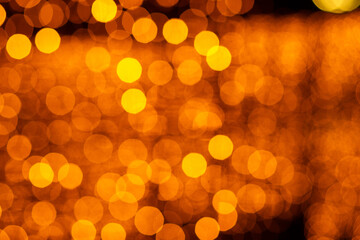 background of many beautiful blurry lights garlands on a dark background. beautiful bokeh. festive...