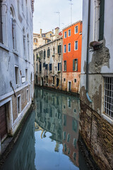 View of old traditional buildings located near the canal. Venice, Italy.