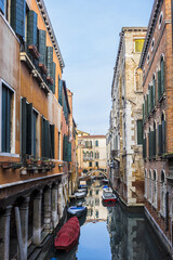 View of old traditional buildings located near the canal. Venice, Italy.