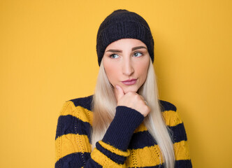 Doubt young woman looking to side, thinking with frowned face expression, isolated on white...