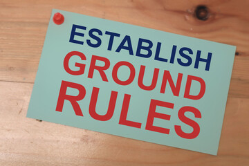 Establish Ground Rules, text words typography written on paper against wooden background, life and...