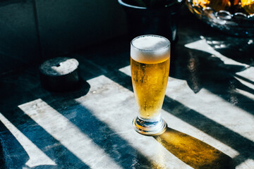 Glass of beer on a concrete counter