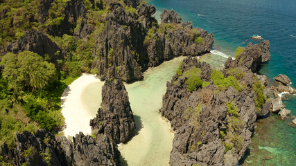 Tropical lagoon with sandy beach surrounded by cliffs. El nido, Philippines, Palawan. beautiful lagoon and karst scenery.