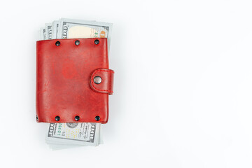Red leather hand made wallet with dollars. Isolated on white background with copy space.