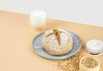 Isometry diagonal projection creative beige background with green buckwheat bread nd organic buckwheat milk. Harmless, wellness, gluten free healthy baking. Alternative bread. Copy spase