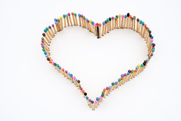a heart shape made of multicolored matchsticks
