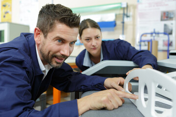 man and a woman checking finishing