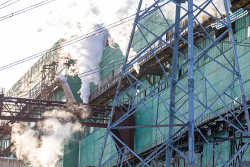 Air pollution from a natural gas and coal power plant. Emissions of harmful substances into the atmosphere. Traditional hydrocarbon energy. Electricity and heat production. Ecological concept.