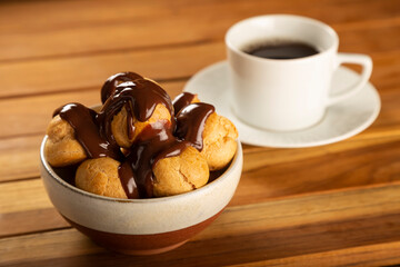 Profiteroles covered with chocolate sauce.