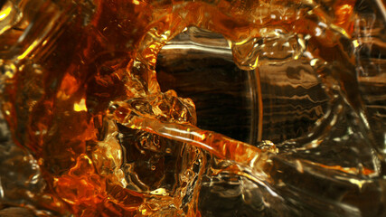 Top shot of ice cube splashing into glass of whisky