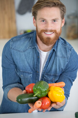happy man with vegetables in hands