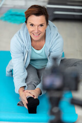 Fototapeta premium senior woman recording fitness blog