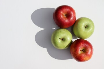 Red apples and green apples on white background.
